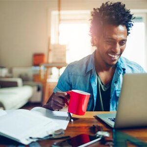 student at laptop with red solo cup